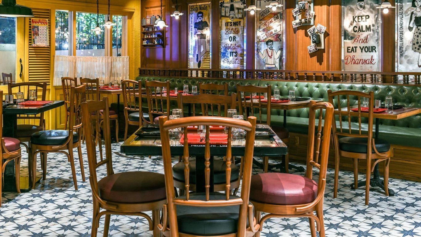 Interior of a historic Irani cafe in Mumbai with bentwood chairs and chequered floor