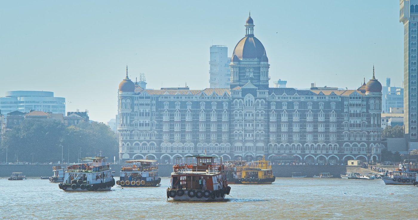 Boats on Mumbai harbour below the Gateway of India in morning haze