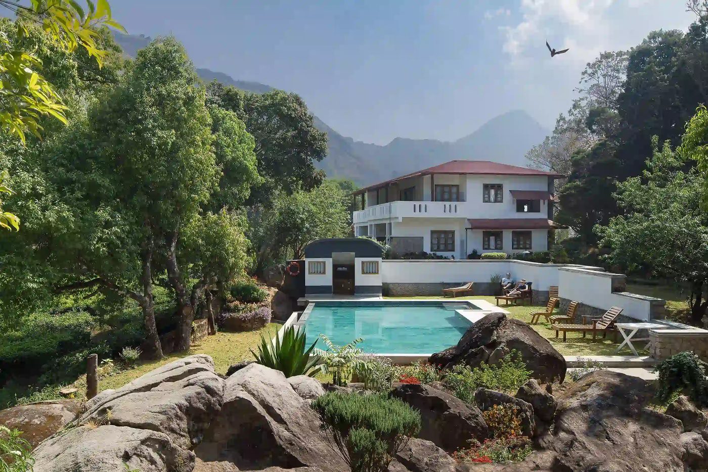 A hill-station house above Panchgani with long verandahs and mist