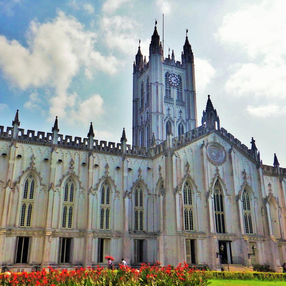 Gothic chapel spire and lawn, in the register of an Indian hill-station school